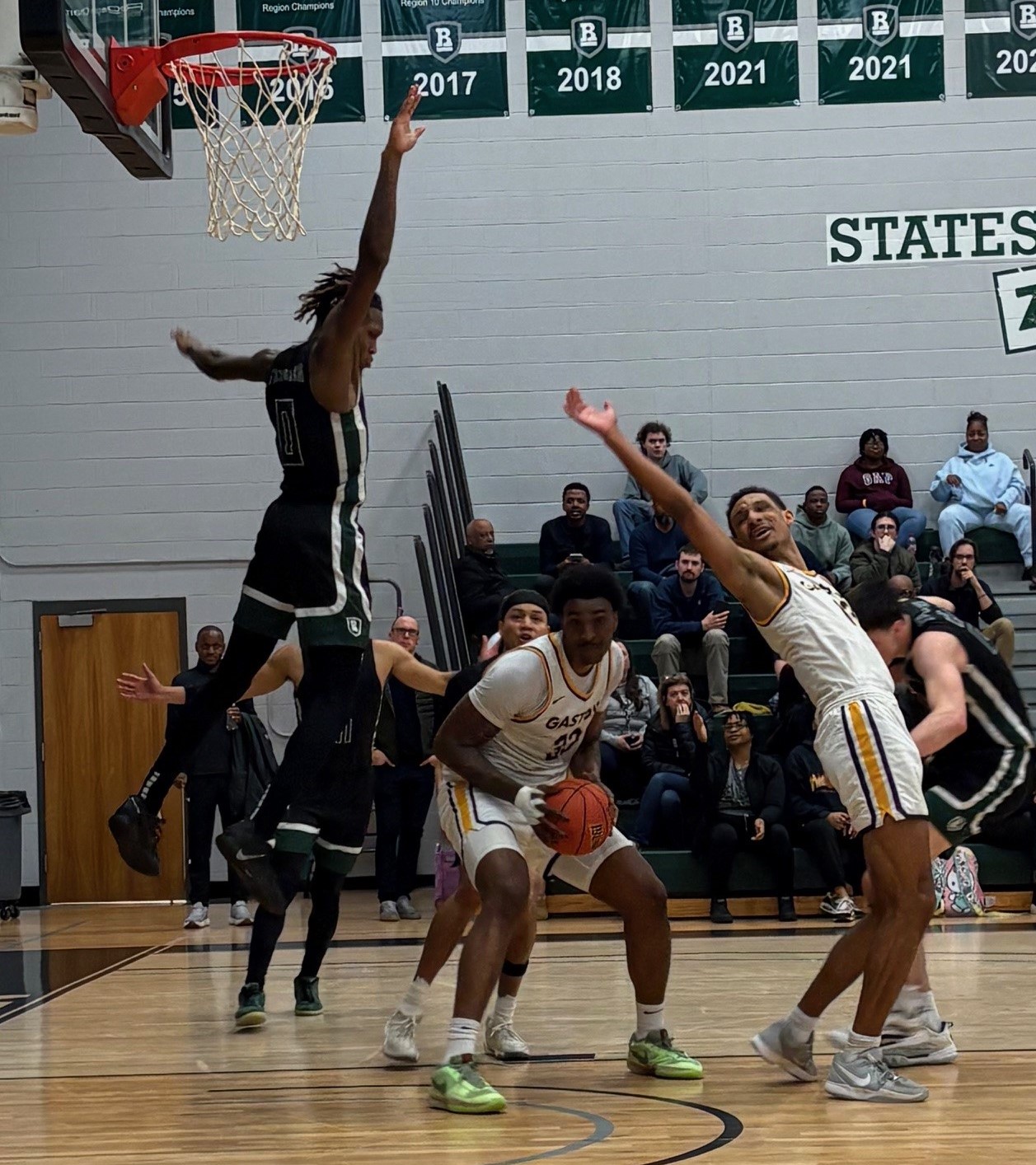 Gaston College's Kaleb Siller (middle) works for two of his game-high 25 points in Friday's Region 10 semifinal victory at Richard Bland.