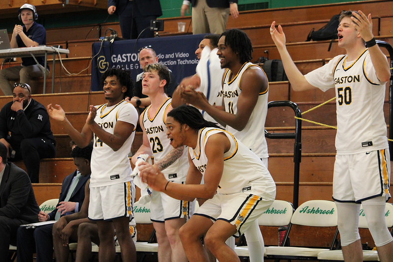 Gaston College players celebrate during the Rhinos' 104-89 win over Brunswick Community College in the 2026 home finale at Gastonia's Ashbrook High School that clinched the top seed in this week's Region 10 tournament.