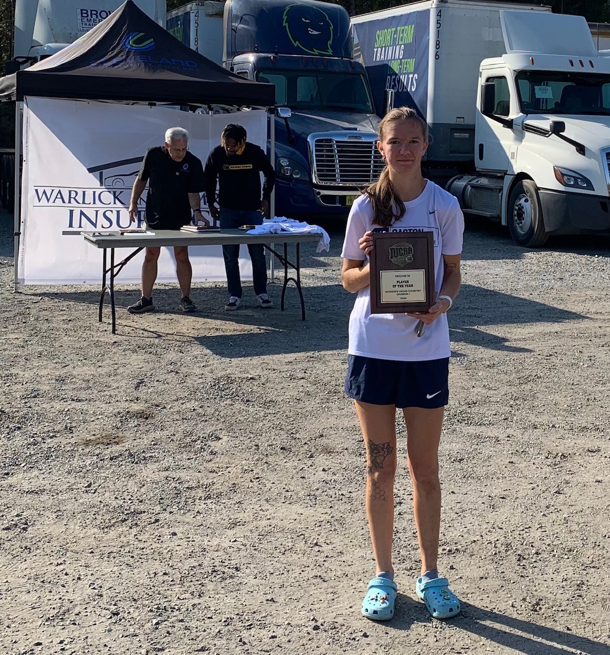Keirieonna Wilson shows off her 2024 Region 10 women's cross country championship plaque.