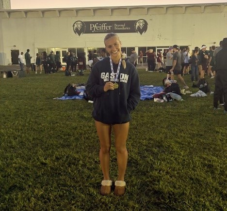 Gaston College's Lexi Birtwistle with her medal from her top finish at Sept. 12 Pfeiffer Invitational.